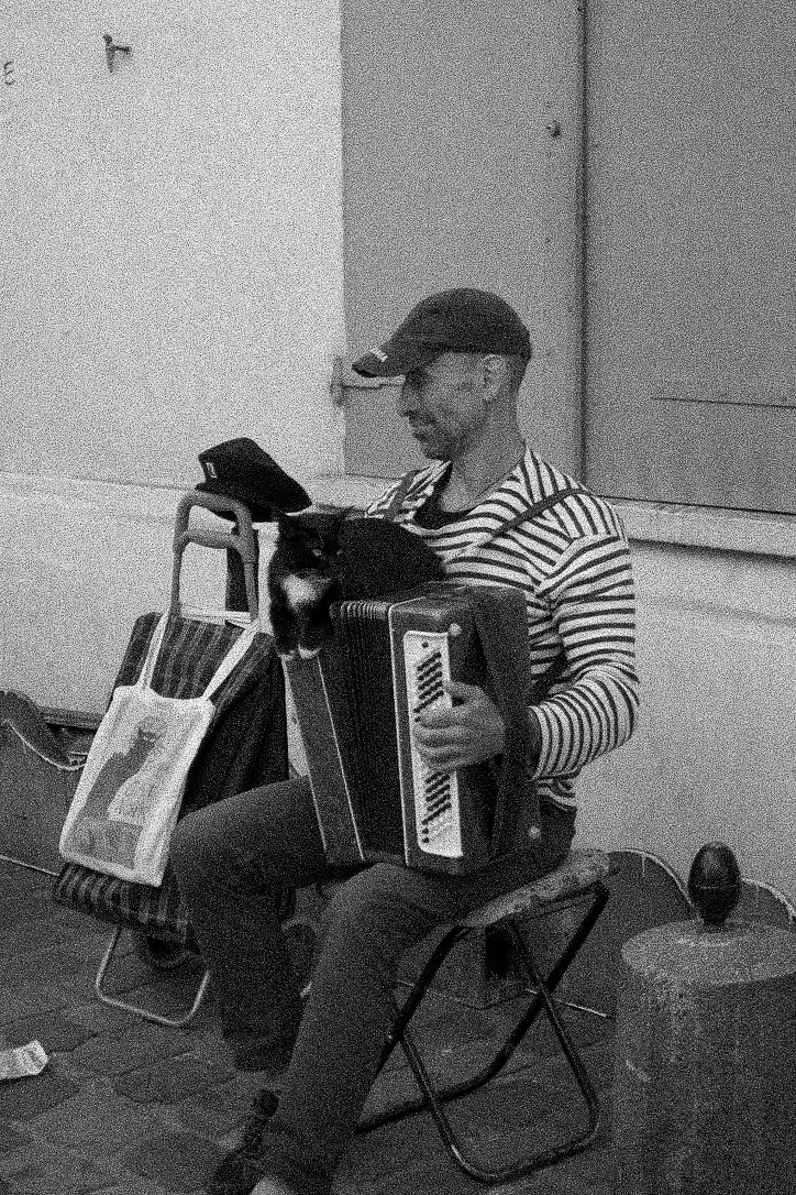 Black and white street portrait of an accordion player