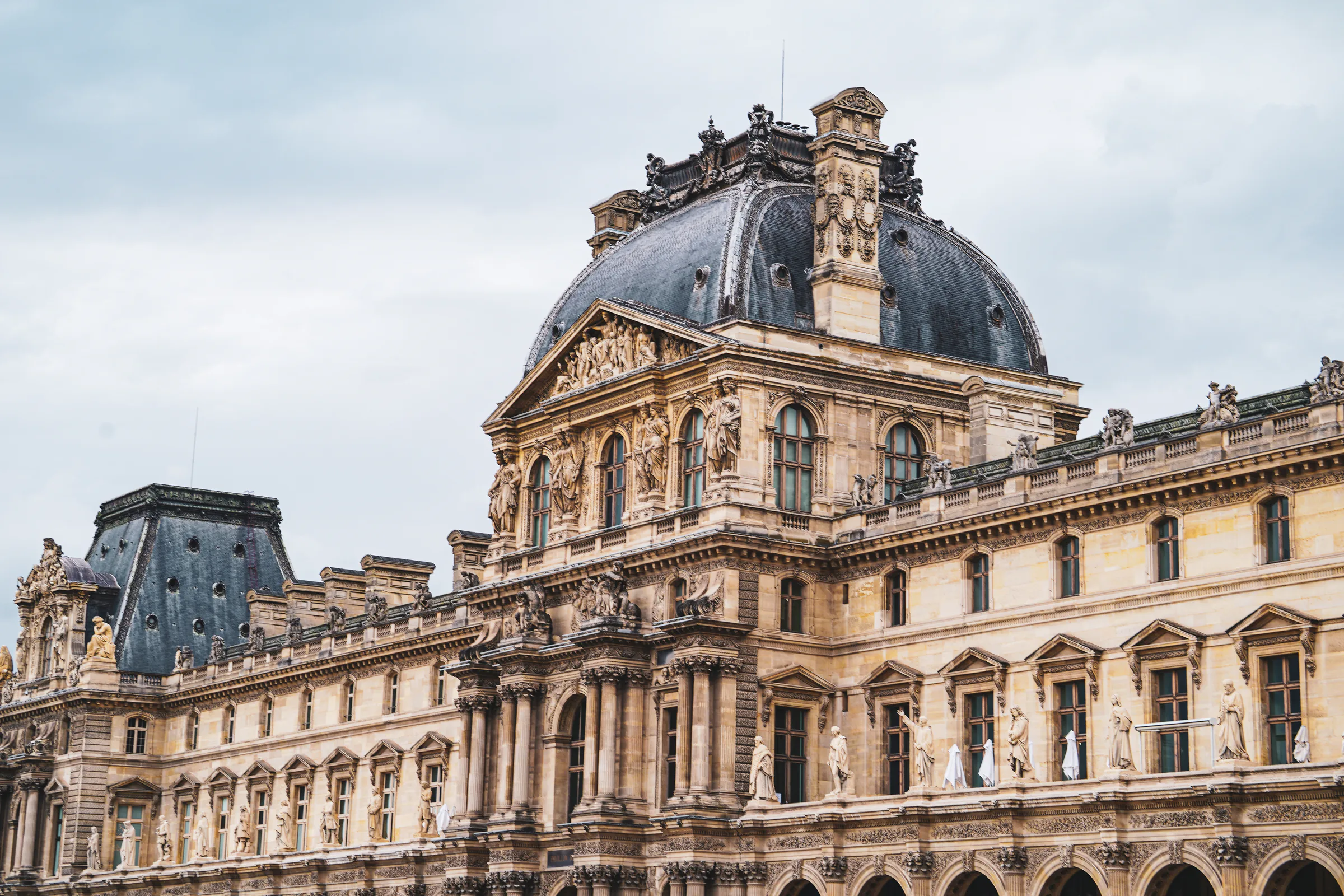 Detailed historic facade and roofline of the Louvre in Paris