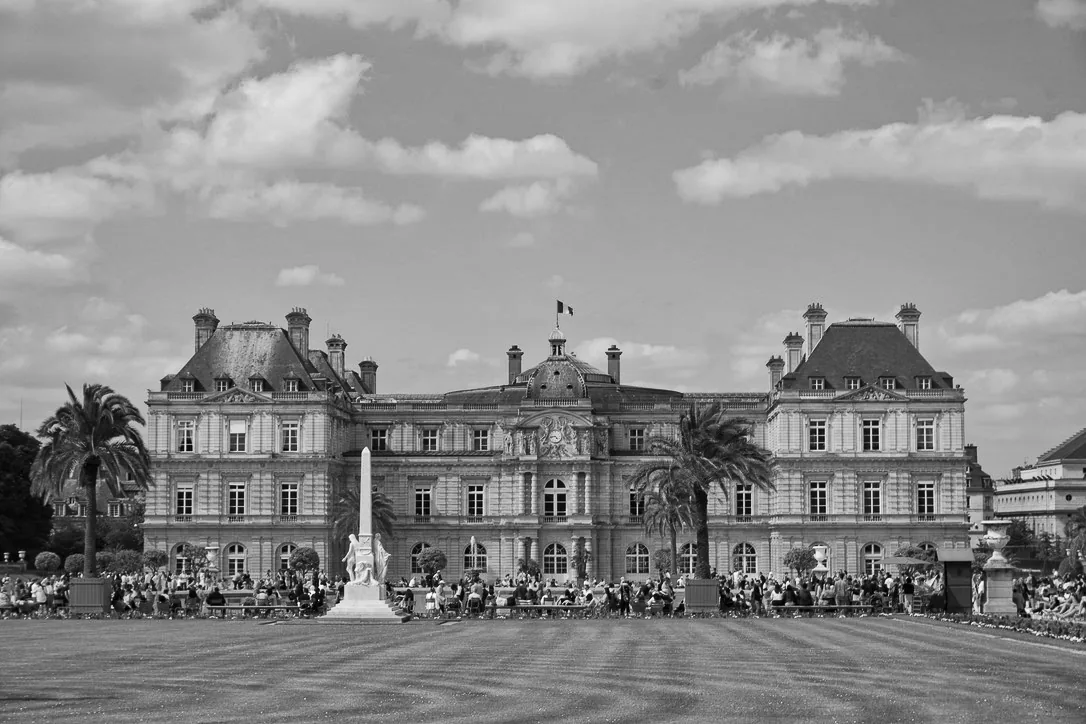 Black and white view of the Luxembourg Palace across its formal gardens